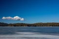 Winter landscape. Fishermen on frozen lake water, pine forest. Bulgaria, Rhodopes mountains, Shiroka Polyana lake.