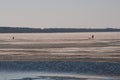 Winter landscape fishermen on the river ice fishing on a spring day Royalty Free Stock Photo