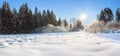 Winter landscape with forest, snow, blue sky and sun Royalty Free Stock Photo