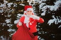 Winter landscape of forest and snow with santa claus. Merry Christmas. Santa on Christmas Eve is carrying presents to Royalty Free Stock Photo