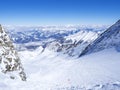 Winter landscape with free ride piste and view on snow covered slopes and blue sky, with Aerial view of Zell am See lake