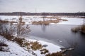 Winter landscape with a freezing river. View of the waterfall. The ice and the banks are covered with snow. Beautiful Royalty Free Stock Photo