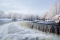 Winter landscape. Frosted trees, river, waterfall, sunlight Royalty Free Stock Photo