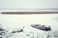 Winter Landscape. Frozen Boat on the Lake.