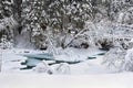 Winter landscape, frozen creek in winter fir forest in snow Royalty Free Stock Photo