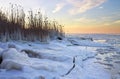 Winter landscape with frozen lake and sunset sky. Royalty Free Stock Photo