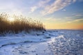 Winter landscape with frozen lake and sunset sky. Royalty Free Stock Photo