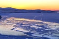 Winter landscape with frozen lake and sunset sky. Composition of nature Royalty Free Stock Photo