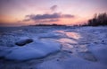 Winter landscape with frozen lake and sunset sky. Royalty Free Stock Photo