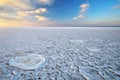 Winter landscape with frozen lake and sunset sky. Royalty Free Stock Photo