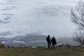 Winter landscape with frozen lake and walker