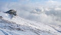 Winter landscape with a house on the mountain with haze and snow Royalty Free Stock Photo