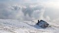 Winter landscape with a house on the mountain with haze and snow Royalty Free Stock Photo