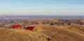 Winter landscape with houses and Denver downtown skyline at the distance