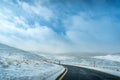 Winter landscape with ice covered bending asphalt road Royalty Free Stock Photo