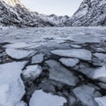 Landscape on a lake during Lofoten islands winter. Snow and ice melting Royalty Free Stock Photo