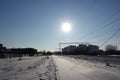 Winter landscape. Low cold sun illuminates the snow-covered railroad. Russia. Moscow region Royalty Free Stock Photo