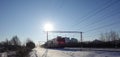 Winter landscape Low cold sun illuminates the snow-covered railway. Freight train goes to Moscow. Russia Royalty Free Stock Photo