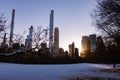 Winter Landscape and Midtown Manhattan Skyline along the Snow Covered Sheep Meadow at Central Park in New York City during a Sunse Royalty Free Stock Photo