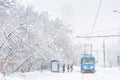 Winter landscape in winter, Moscow, Russia. Frozen tram on snowy street. People wait transport at ice stop. Cold and snowfall in Royalty Free Stock Photo