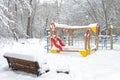 Winter landscape in Moscow, Russia. Scenery of empty snowy bench and playground. Scenic view of urban park under snow Royalty Free Stock Photo