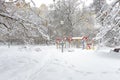 Winter landscape in Moscow, Russia. Scenery of snowy trees and playground. Panoramic scenic view of an empty urban park under snow Royalty Free Stock Photo