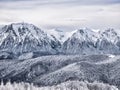 Winter landscape with mountain peaks covered in snow. Beautiful view with Bucegi Mountains part of the Carpathian Mountains, in Royalty Free Stock Photo
