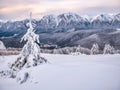 Winter landscape with mountain peaks covered in snow. Beautiful view with Bucegi Mountains part of the Carpathian Mountains, in Royalty Free Stock Photo
