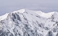 Winter landscape with mountain peaks covered in snow. Beautiful view with Bucegi Mountains part of the Carpathian Mountains, in Royalty Free Stock Photo