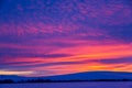 Winter landscape with mountains during amazing vivid saturated beautiful sunset sky in pink, purple and blue colors. Sunset