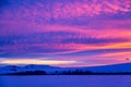Winter landscape with mountains during amazing vivid saturated beautiful sunset sky in pink, purple and blue colors. Sunset