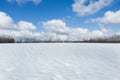 Winter landscape outside the city. Field in snow and bright blue sky Royalty Free Stock Photo