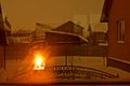 Winter landscape outside the window with reflection of fire in the fireplace