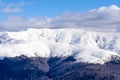 Winter landscape over Carpathian Mountains. Panorama of snow mountain range landscape with blue sky and white clouds from Royalty Free Stock Photo