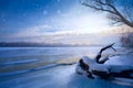 winter landscape panorama; sunset on the bank of a frozen river; ice and snow Royalty Free Stock Photo