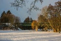Winter landscape, a park with green iron railway bridge Royalty Free Stock Photo