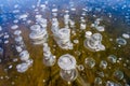 Winter landscape photography, air bubbles froze in the water. Fancy drawing