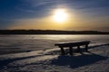 Winter landscape picture in Finland. Empty park bench in front.