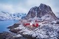 Winter landscape of picturesque fishing village with red rorbus in the mountains of Lofoten islands Royalty Free Stock Photo