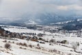 Winter Landscape Of Poland Tatra Mountains. Snow-covered Valley With Many Traditional Polish Houses At The Background Of Snow-Capp