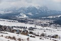 Winter Landscape Of Poland Tatra Mountains. Snow-covered Valley With Many Traditional Polish Houses At The Background Of Snow-Capp