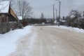 Winter landscape. poorly cleaned the road. Cat on the road. A lot of snow.