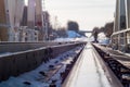 Winter landscape with railroad bridge over frozen river, snow-covered trees Royalty Free Stock Photo