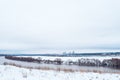 Winter landscape, river against a forest of snow-covered trees. Beautiful winter background in nature. White hills in Royalty Free Stock Photo