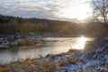 Winter landscape of river with sun reflections Royalty Free Stock Photo