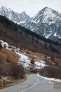 winter landscape, road in the autumn forest, alley, fallen trees, coniferous forest and the first snow, mountains Royalty Free Stock Photo