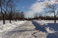 Winter landscape of the road, church and street lamp on background of blue sky.