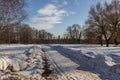 Winter landscape of the road, church and street lamp on background of blue sky.