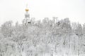 Winter landscape with Russian church on the hill and frozen forest under it in the overcast day Royalty Free Stock Photo