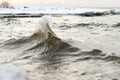 Winter landscape from the sea shore, blurred wave slag against frozen ice cubes, blurred background